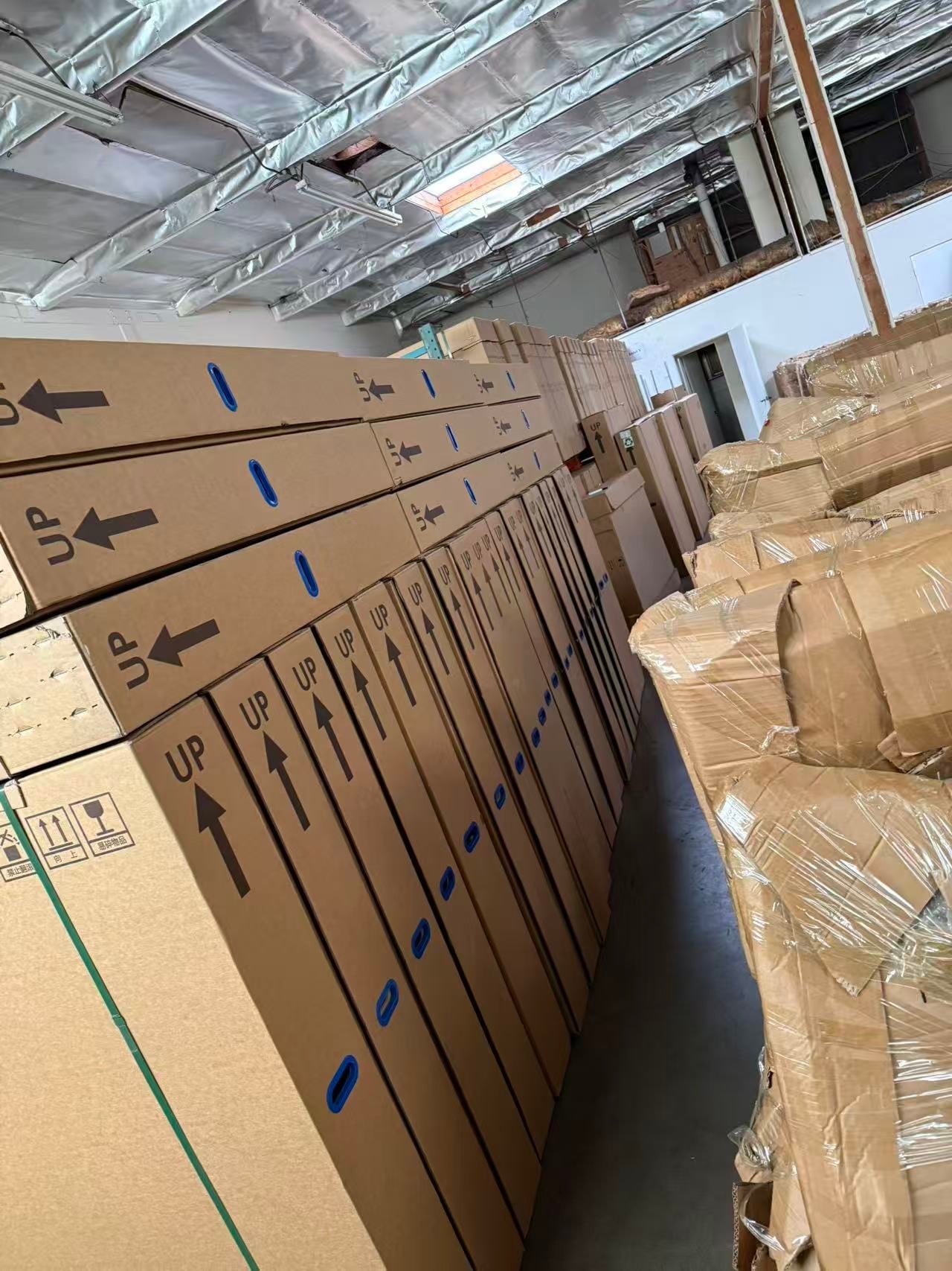 Stacked Tesla part boxes in GD Auto Parts warehouse